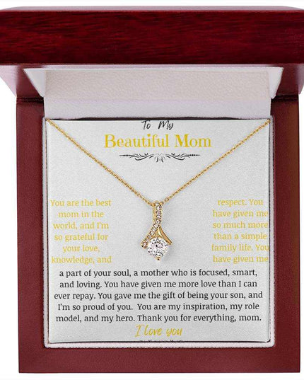 A yellow gold Alluring Beauty Necklace up close in a mahogany box.