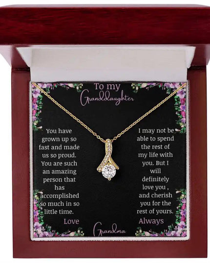 Alluring Beauty Necklace with a yellow gold charm with a to granddaughter from grandma greeting card up close in a mahogany box