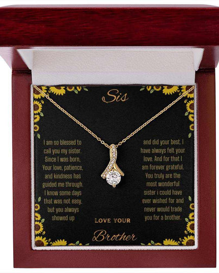 Alluring Beauty Necklace with a yellow gold variant on a To Sis from Brother greeting card inside a mahogany close up view