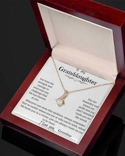 a yellow gold alluring beauty necklace up close in a mahogany box angled right