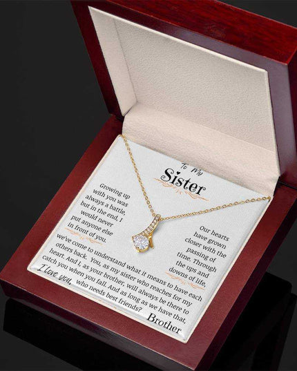 a yellow gold alluring beauty necklace in a mahogany box angled right.