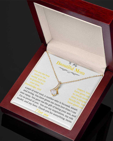A yellow gold Alluring Beauty Necklace up close in a mahogany box angled to the right.