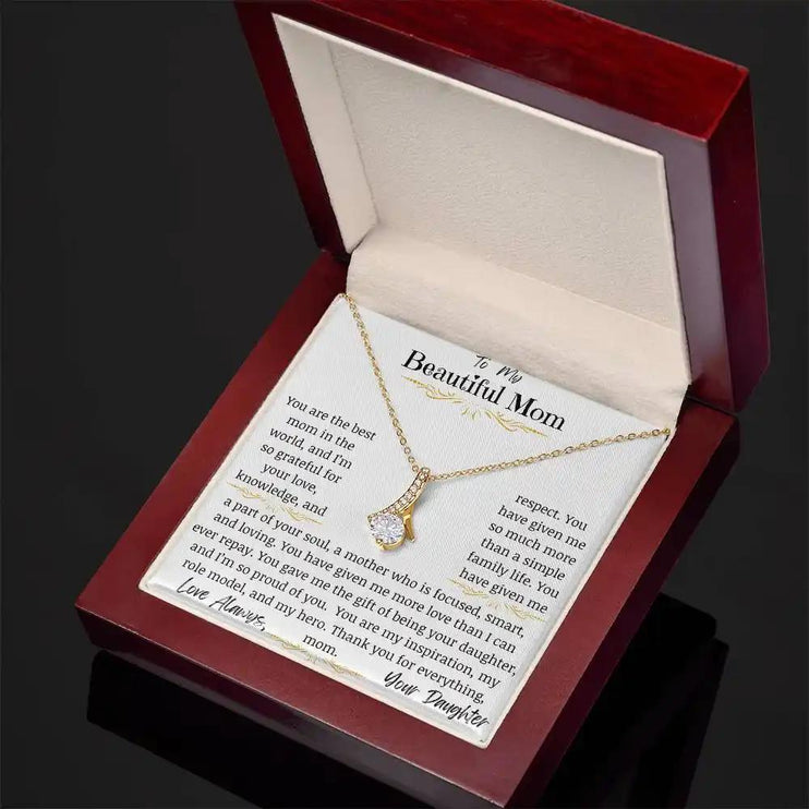 a yellow gold alluring beauty necklace in a mahogany box angled right