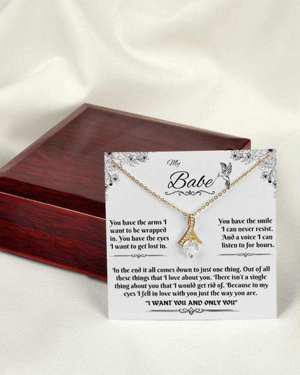 yellow gold alluring beauty necklace on a message card outside of box