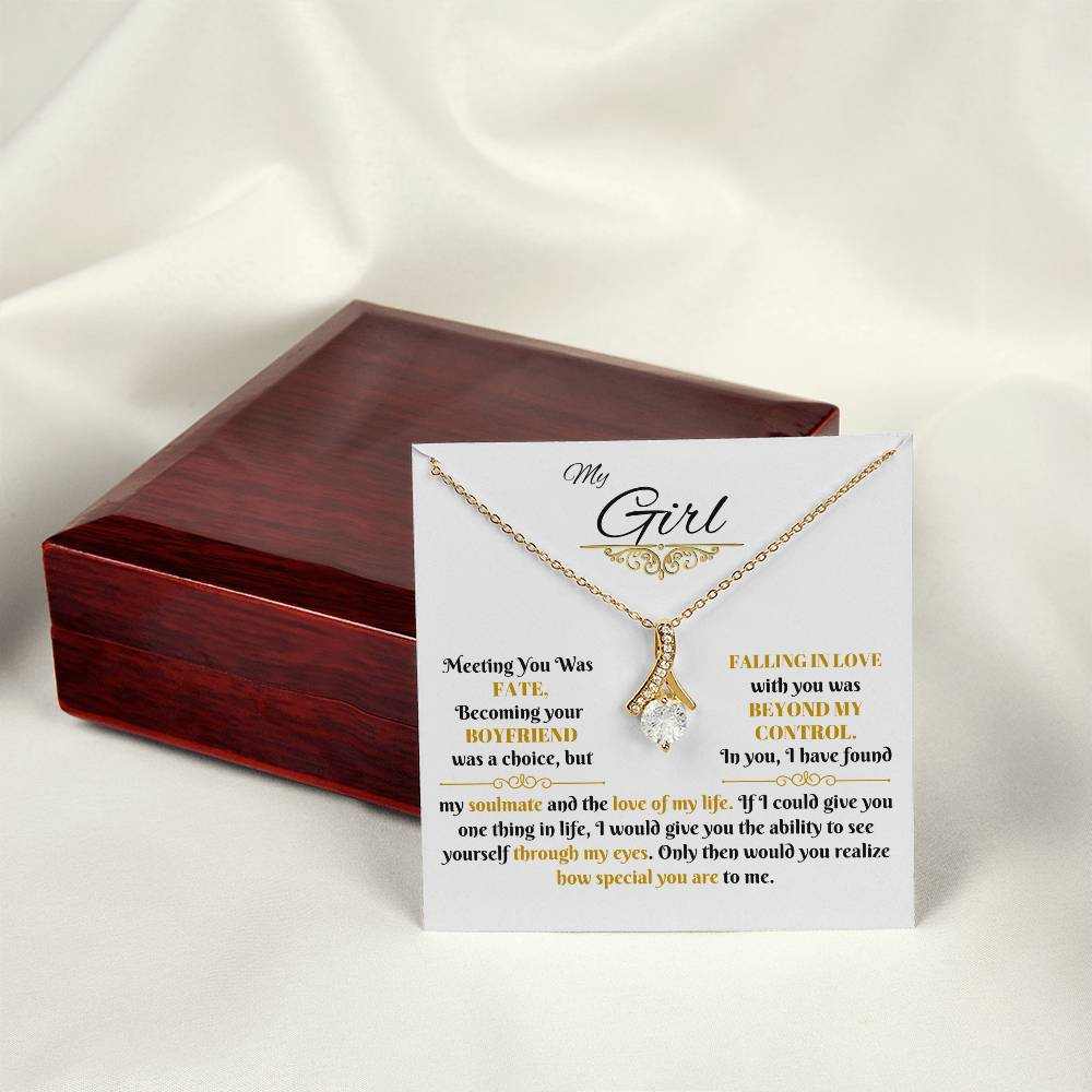 yellow gold alluring beauty necklace on a message card beside a luxury box