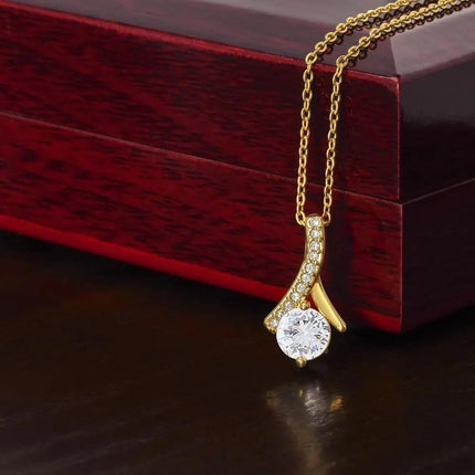 yellow gold alluring beauty necklace on top a mahogany box