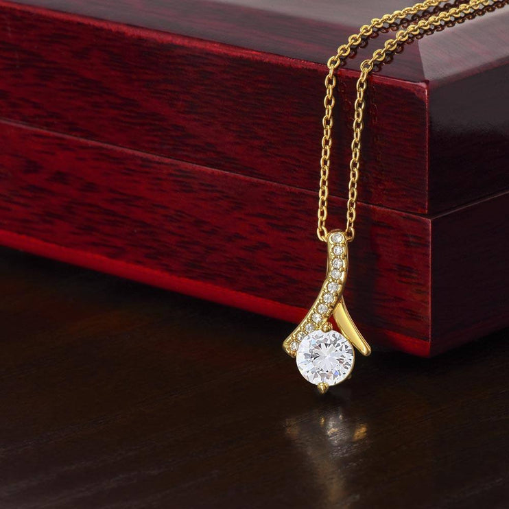 yellow gold alluring beauty necklace on top of closed luxury box