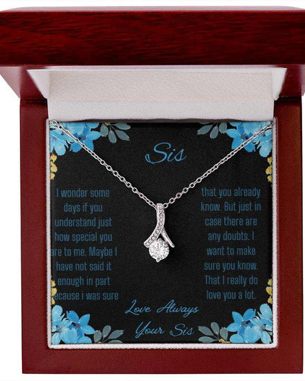 Alluring Beauty Necklace with a white gold variant on a to sis from sis greeting card inside a mahogany box with a close up view.