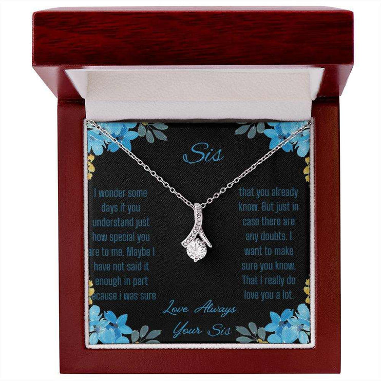 Alluring Beauty Necklace with a white gold variant on a to sis from sis greeting card inside a mahogany box with a close up view.