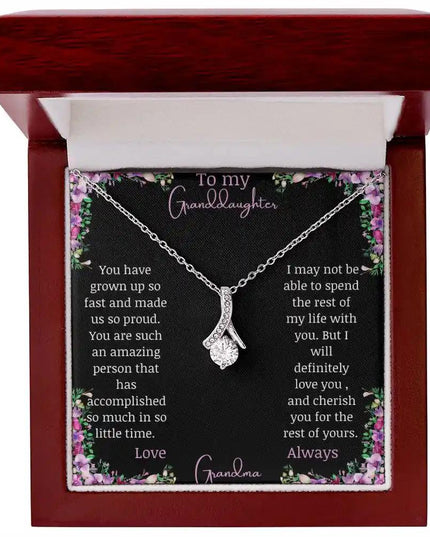 Alluring Beauty Necklace with a white gold charm with a to granddaughter from grandma greeting card up close in a mahogany box