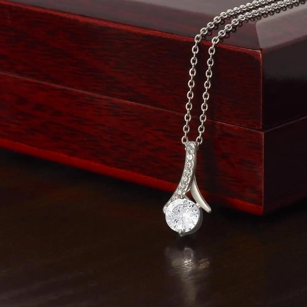 white gold alluring beauty necklace in on top of mahogany box