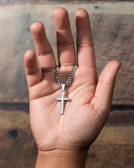 Cuban Chain Necklace hanging from finger.