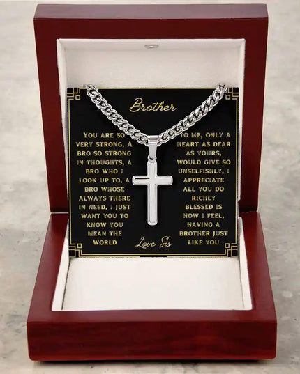 A artisan cross personalized cuban link chain in a mahogany box with a to brother greeting card on a table 