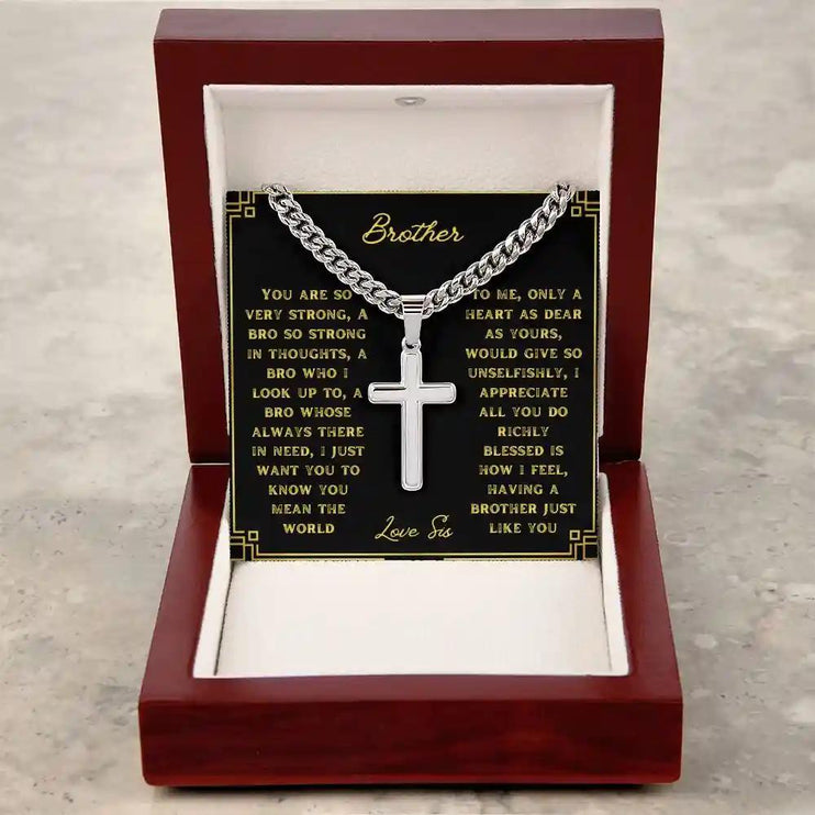 A artisan cross personalized cuban link chain in a mahogany box with a to brother greeting card on a table 
