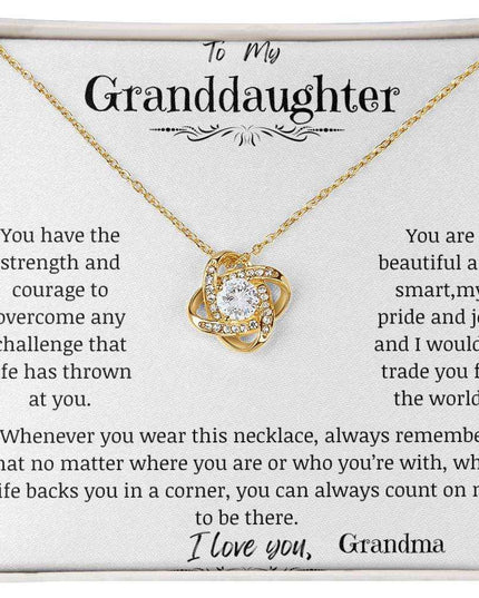 a yellow gold love knot necklace up close