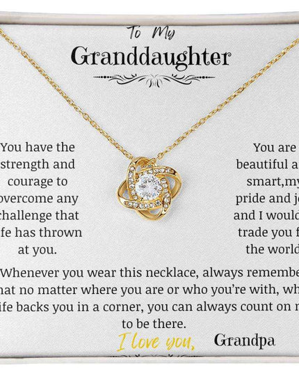 a yellow gold love knot necklace up close