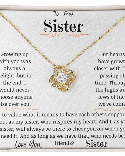 a yellow gold love knot necklace up close.