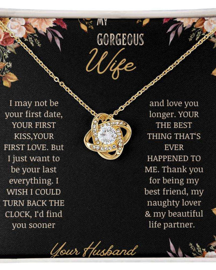 A yellow gold love knot necklace on a to wife greeting card.
