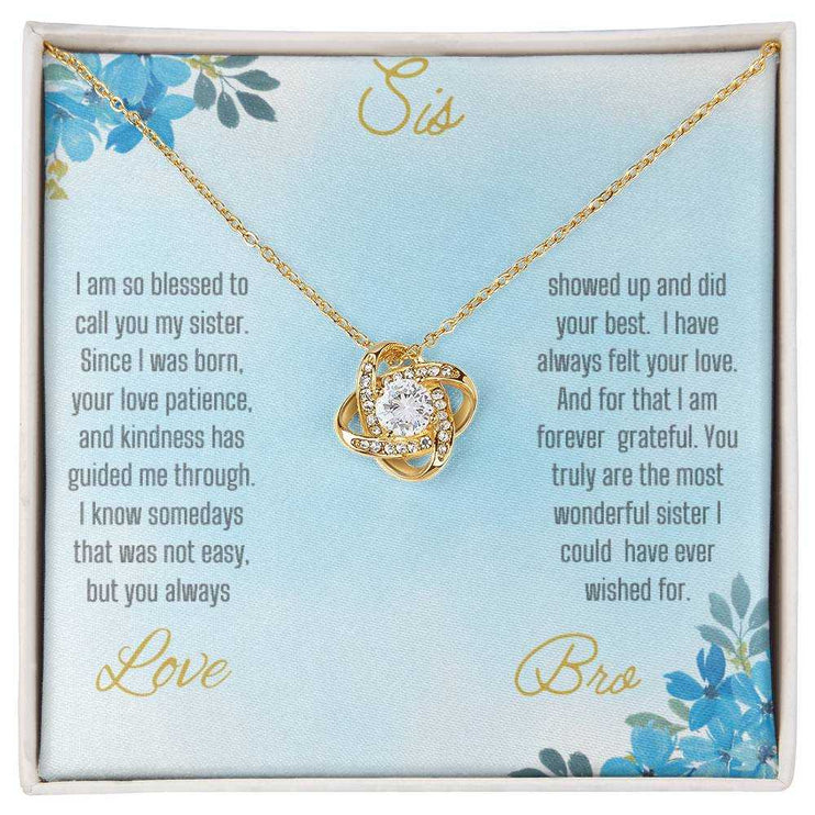 Love Knot Necklace with a yellow gold pendant on a To Sis from Bro greeting card close view