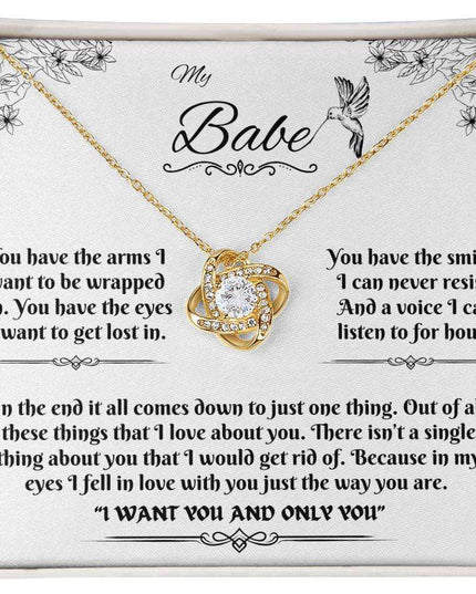 yellow gold love knot necklace in soft box up close