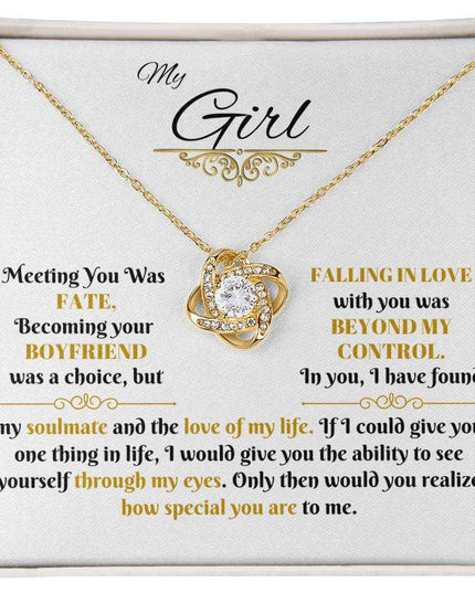yellow gold love knot necklace in a soft box up close