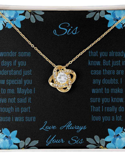 Love Knot Necklace with a yellow gold variant on a To Sis from Sis greeting card close up view