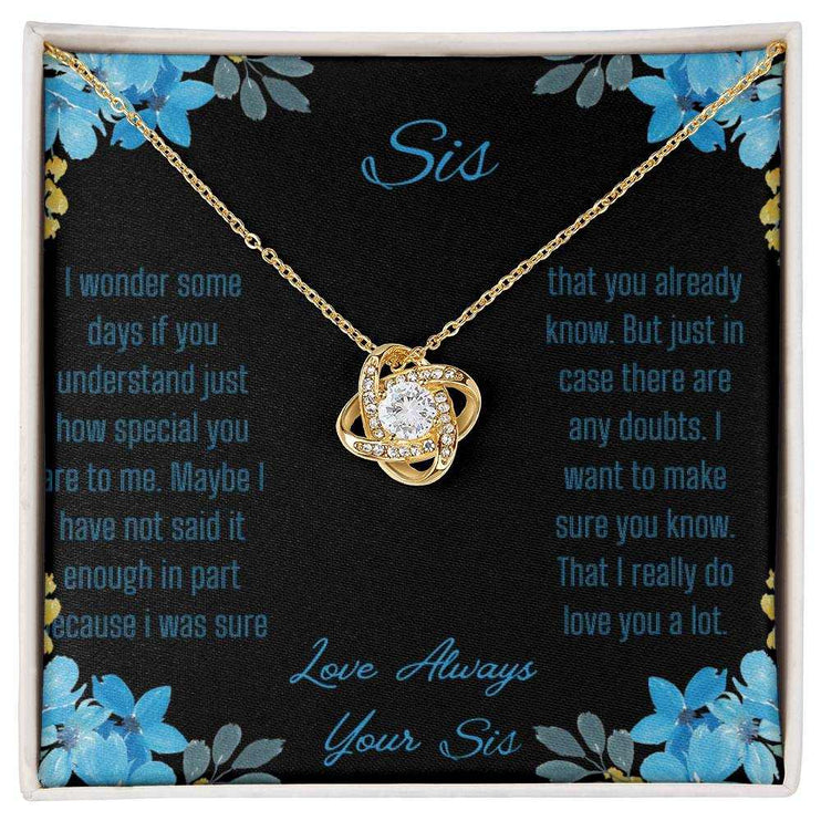 Love Knot Necklace with a yellow gold variant on a To Sis from Sis greeting card close up view