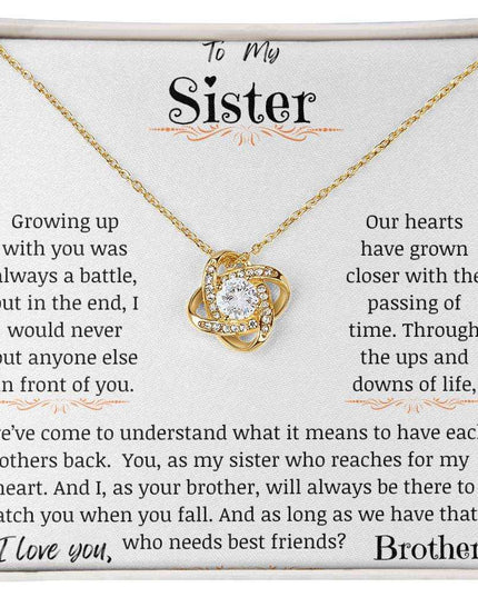 a yellow gold love knot necklace up close
