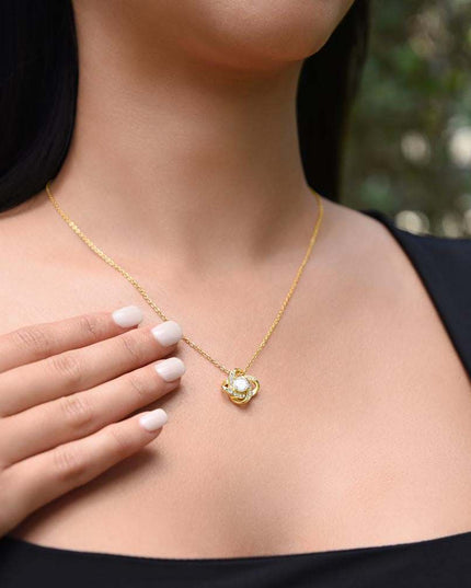 yellow gold love knot necklace on a model's neck