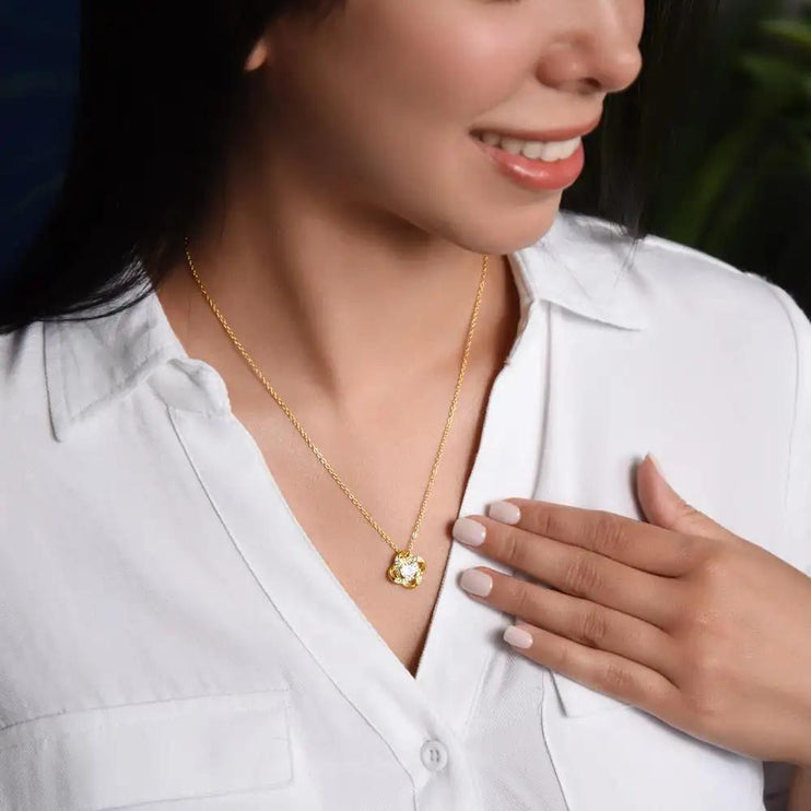 yellow gold love knot necklace on model's neck