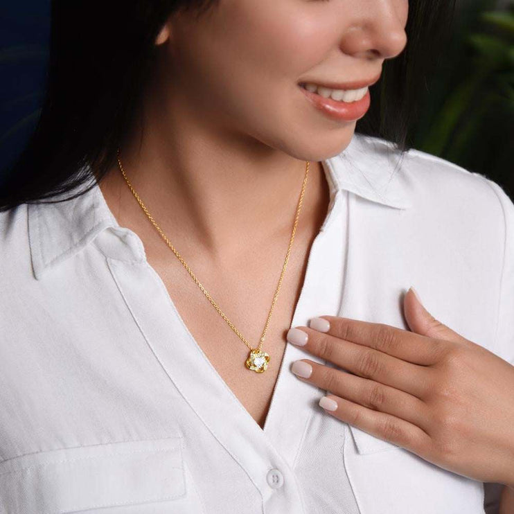 18k gold love knot necklace on a model's neck