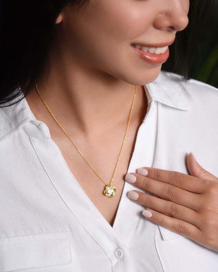 yellow gold love knot necklace on a model's neck