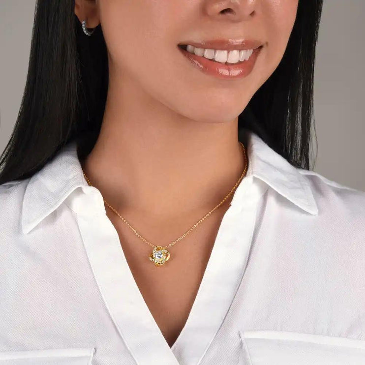 yellow gold love knot necklace on model's neck