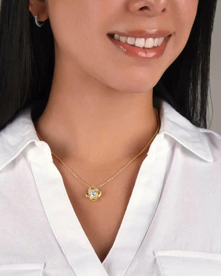 yellow gold love knot necklace on model's neck