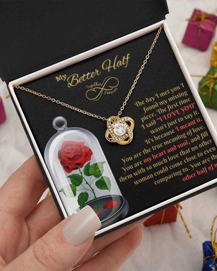18k gold love knot necklace in soft box in model's hands