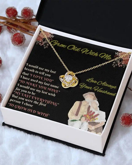 yellow gold love knot necklace in two-tone box angled right