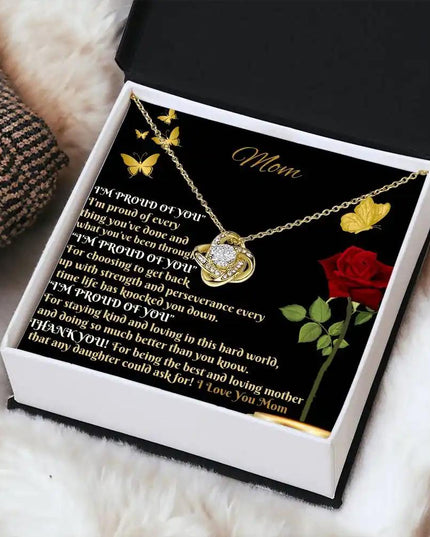 yellow gold love knot necklace in two-tone box angled right
