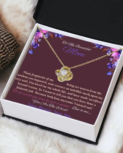 yellow gold love knot necklace in soft box angled right