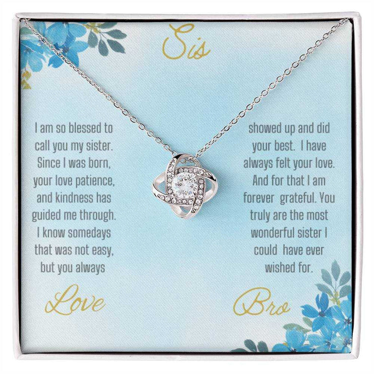 Love Knot Necklace with a white gold pendant on a To Sis from Bro greeting card close view
