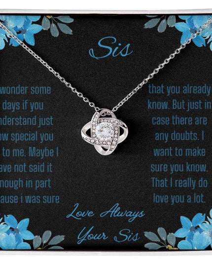 Love Knot Necklace with a white gold variant on a To Sis from Sis greeting card close up view