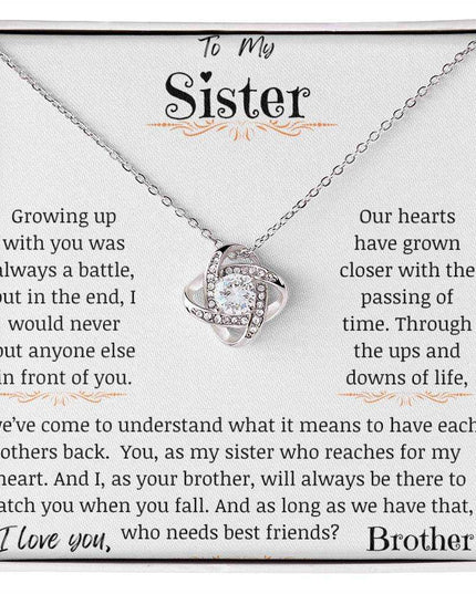 a white gold love knot necklace up close