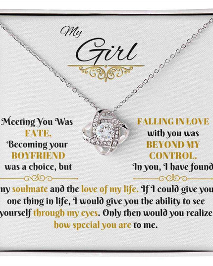 white gold love knot necklace in a soft box up close