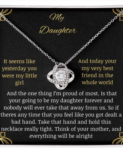 Love Knot Necklace close up with a white gold charm in a two-tone box with a to daughter from mom greeting card 