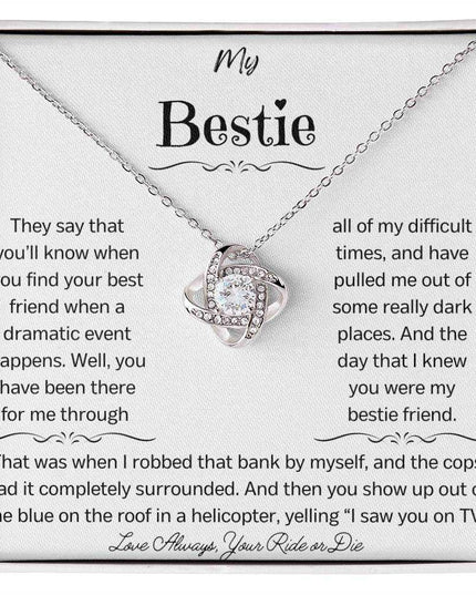 a white gold love knot necklace up close.