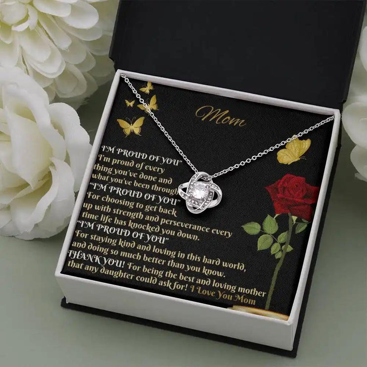 white gold love knot necklace in two-tone box angled right