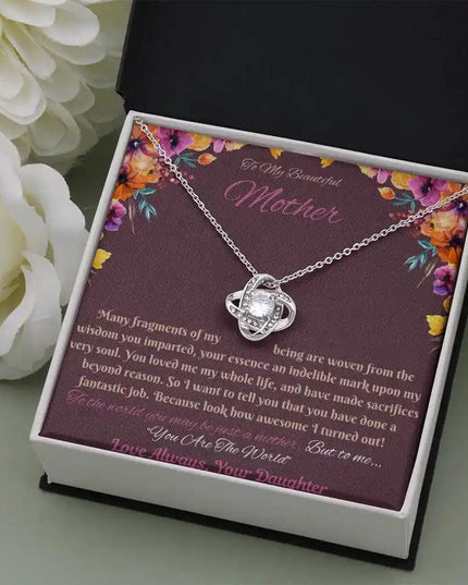 white gold love knot necklace in soft box angled right