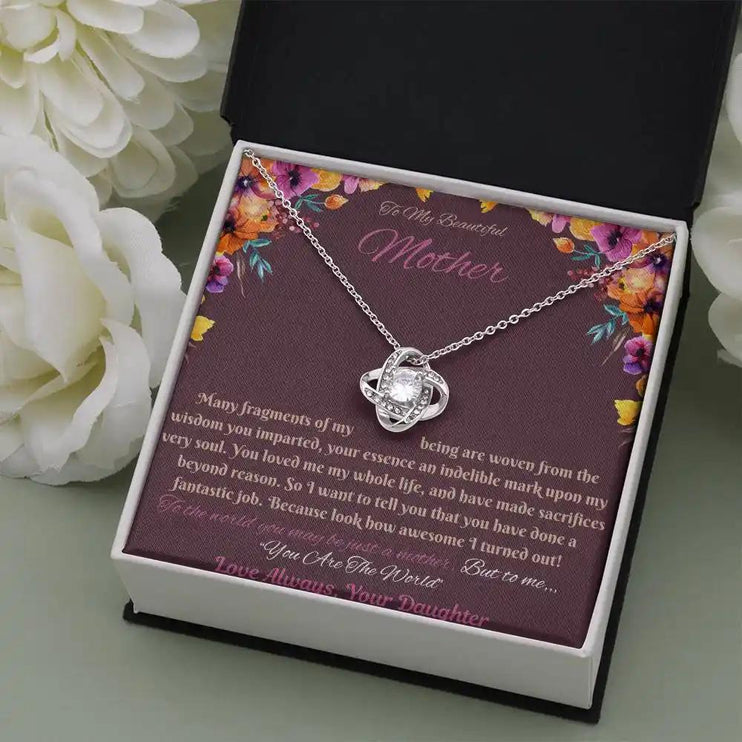 white gold love knot necklace in soft box angled right