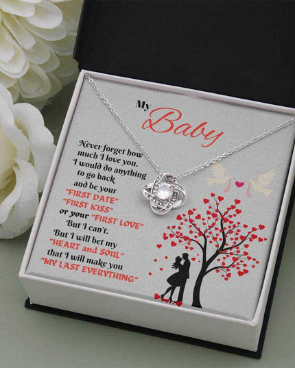 white gold love knot necklace in soft box with white roses