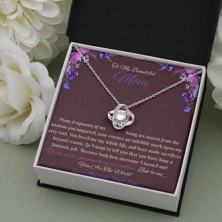 white gold love knot necklace in soft box angled right