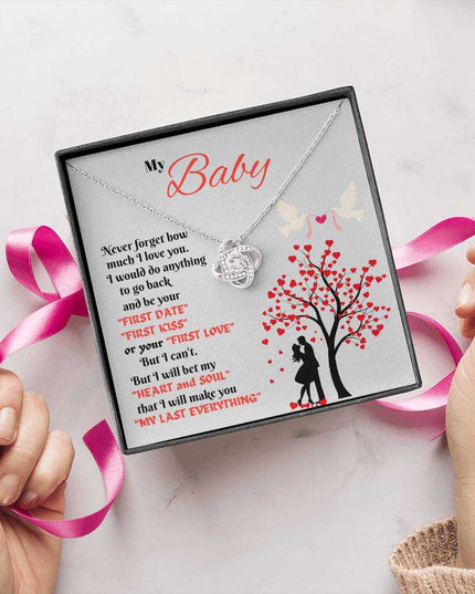 white gold love knot necklace in soft box showing wrapped with a bow